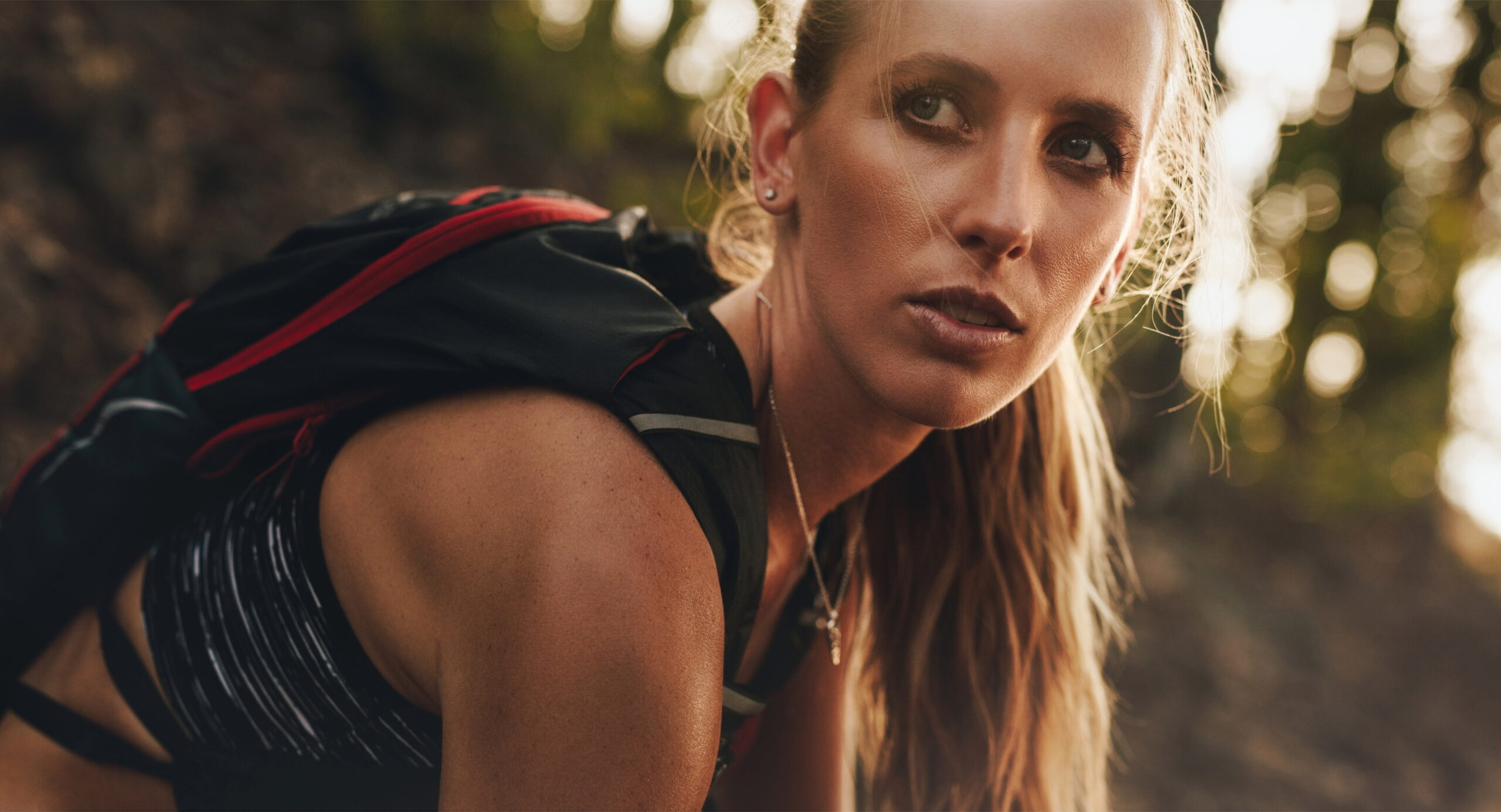 A fatigued female runner looking past the camera